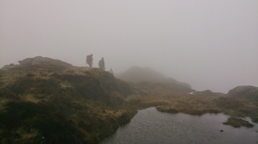 a body of water with a mountain in the background