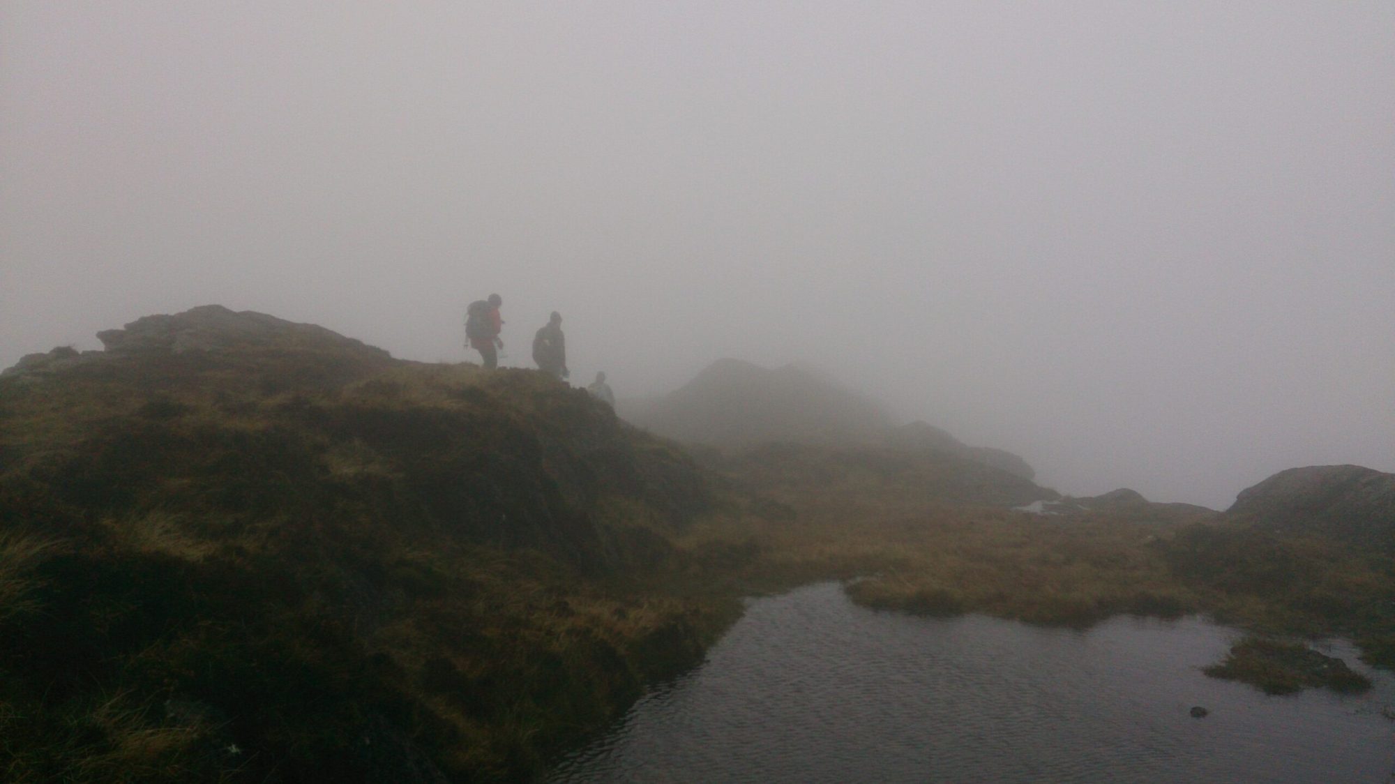 a body of water with a mountain in the background