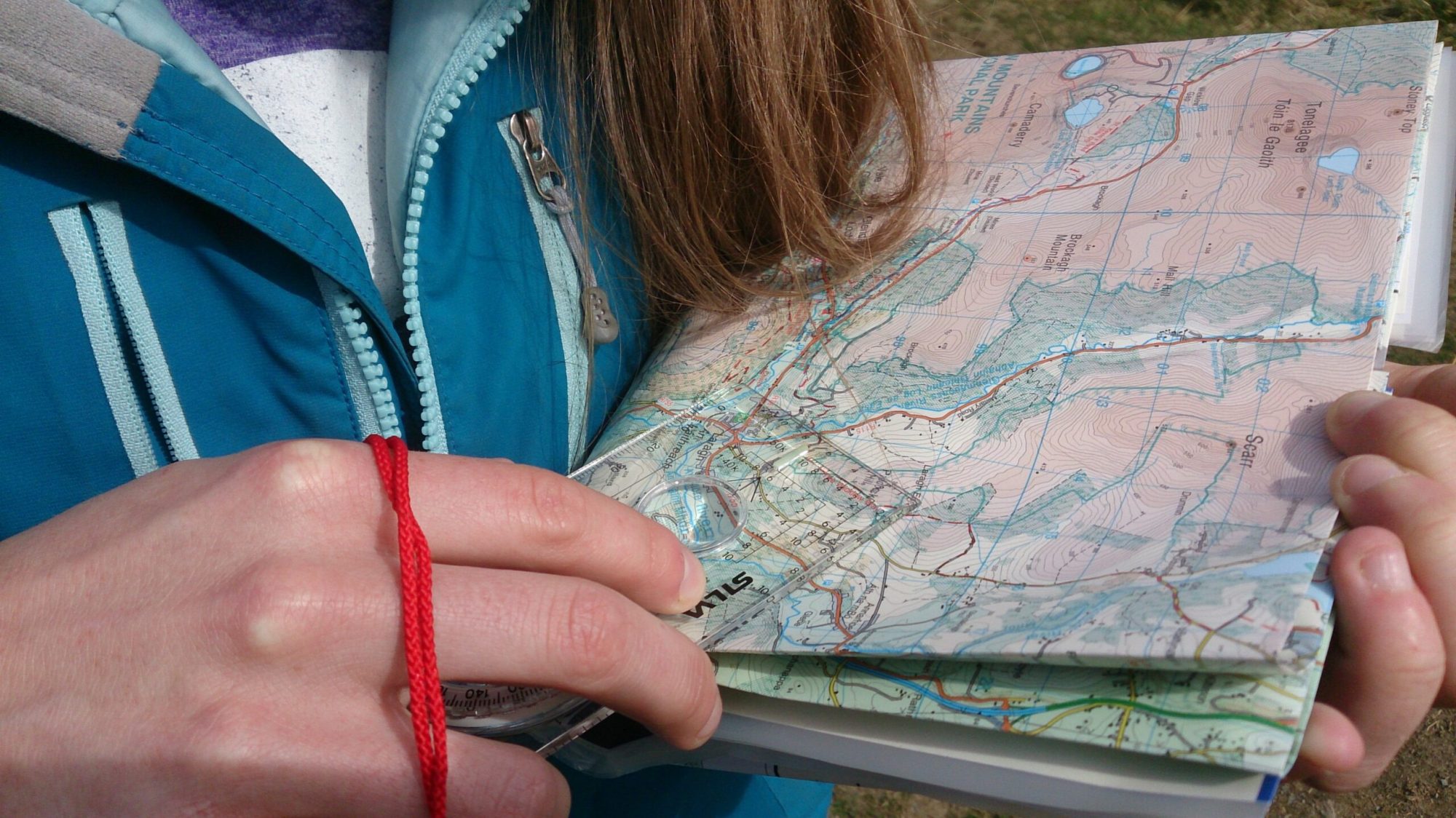 Navigation-training-courses-with-Mountaintrails-min a close up of a person holding a cell phone