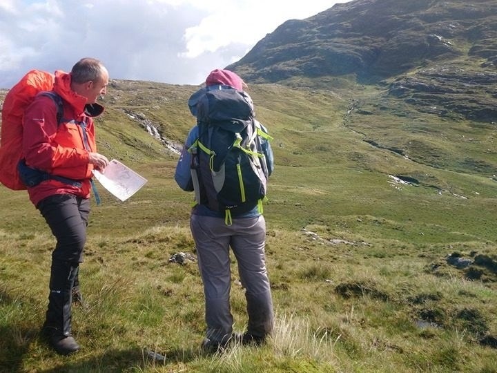 Advanced Navigation Contour Interpretation Workshop in Connemara Image 1 a group of people standing in a field with a mountain in the background