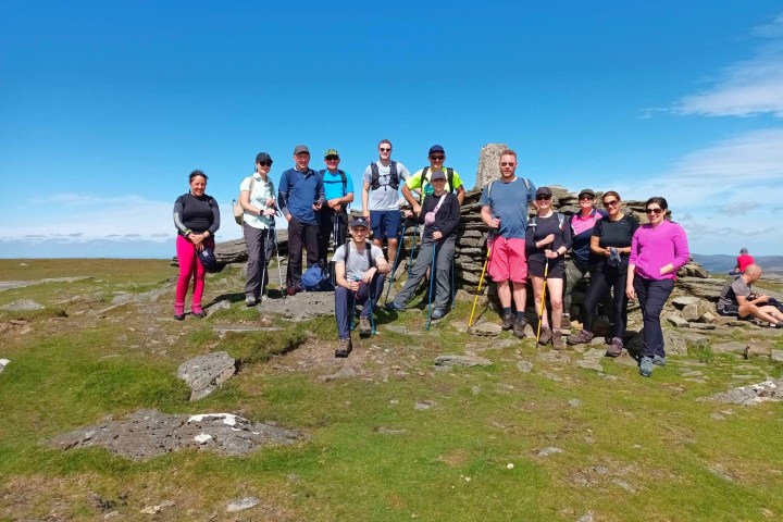 a group of people standing on top of a hill