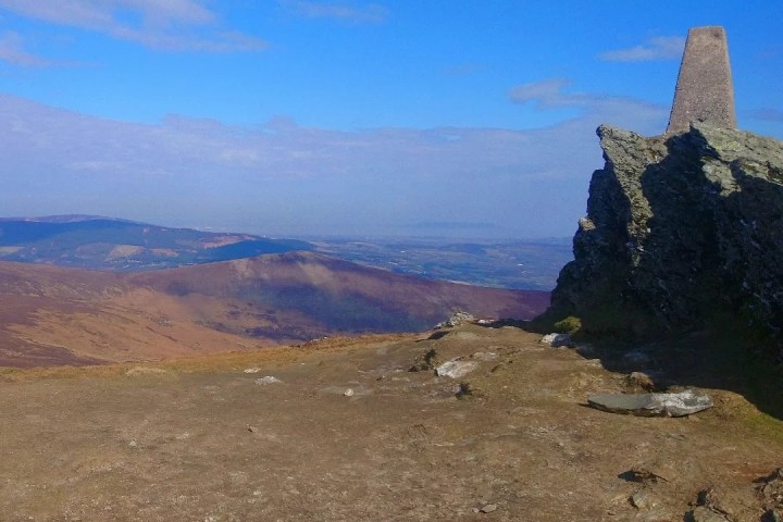 a tower with a mountain in the background