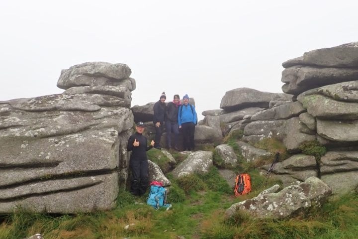 a couple of people that are sitting on a rock
