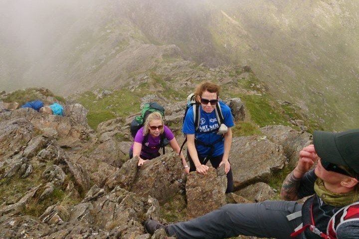 a group of people standing on top of a mountain