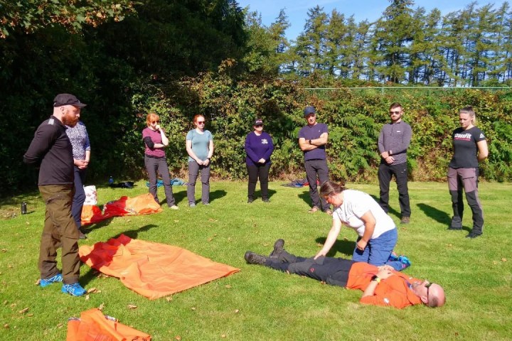 a group of people flying kites in a field