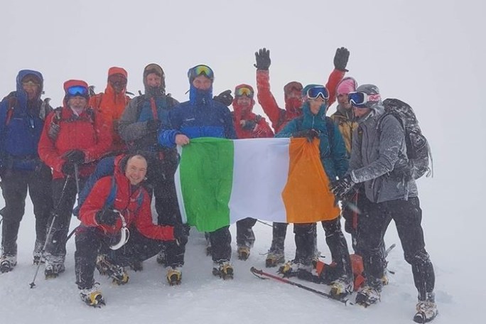 a group of people standing in the snow