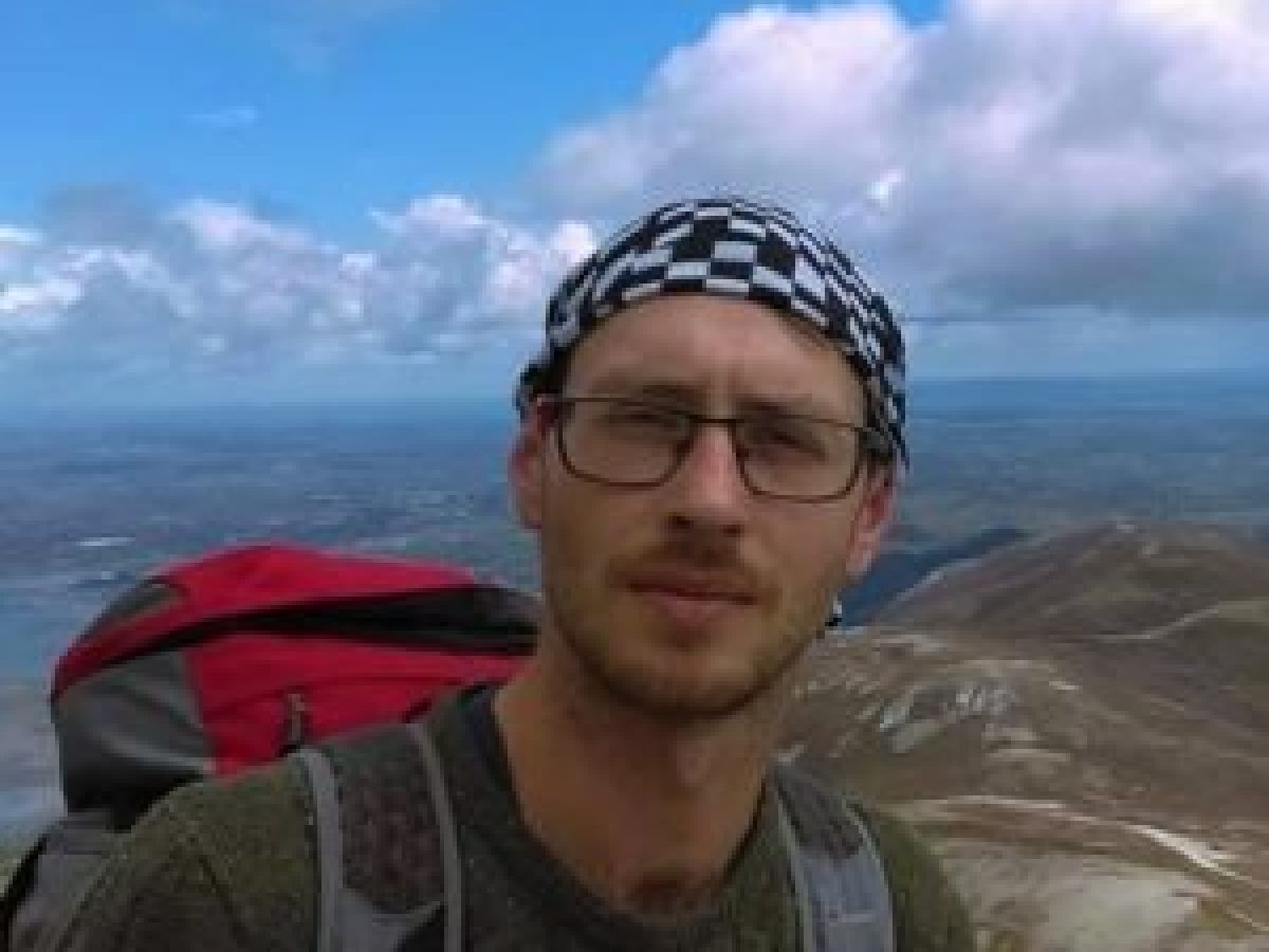 a man standing next to a body of water
