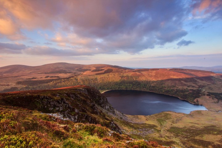 a body of water with a mountain in the background