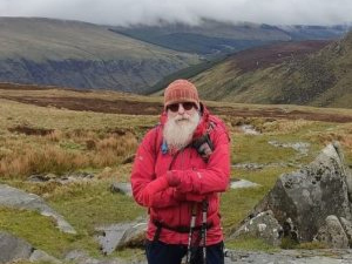 a person standing in front of a mountain